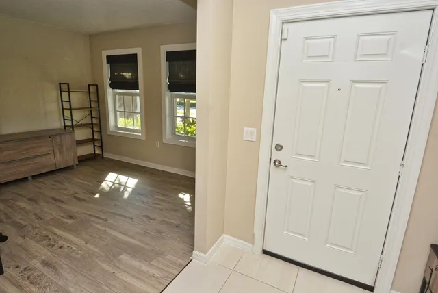 a backyard of a house with lots of green space and lake view