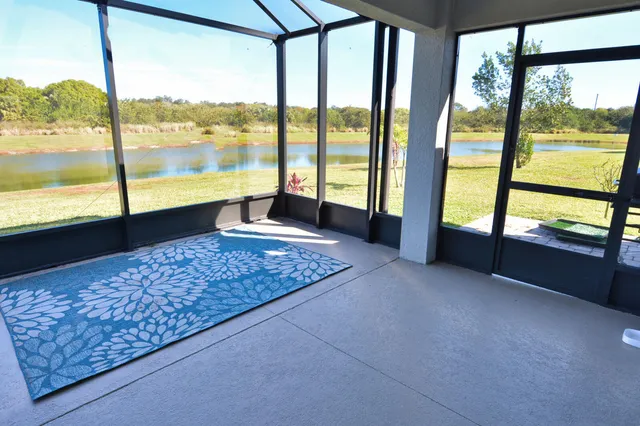 a view of a floor to ceiling window and an outdoor kitchen