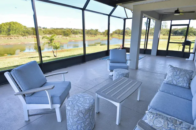 a view of a porch with a table and chairs under an umbrella