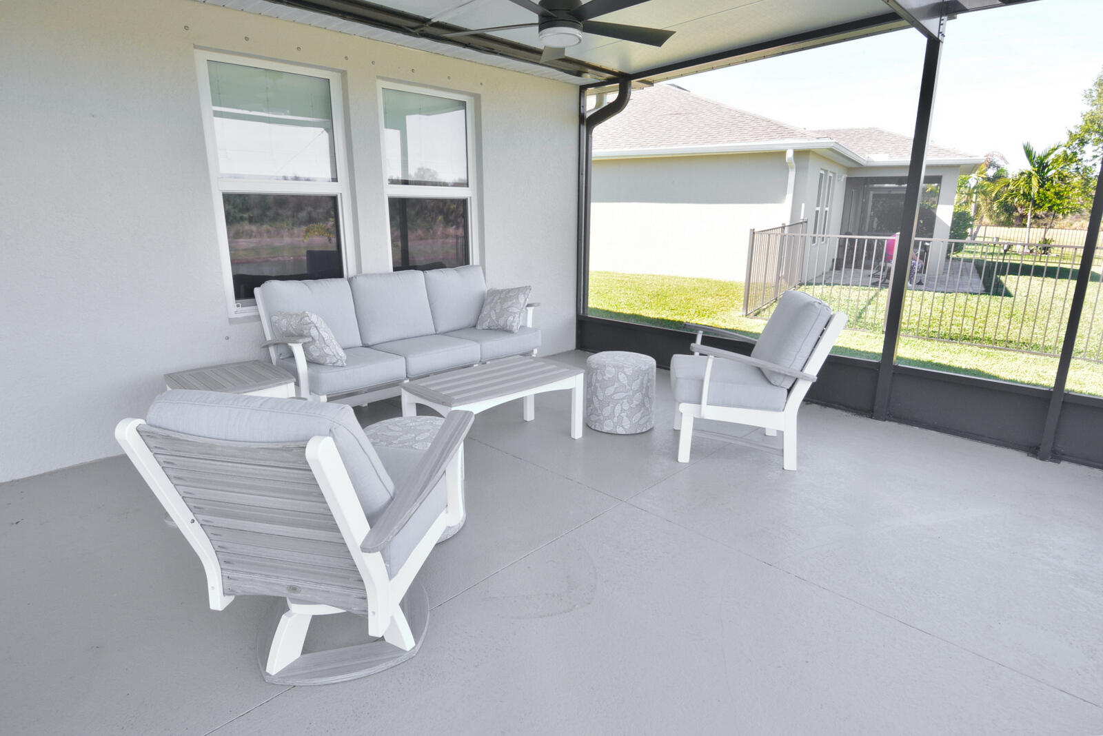 3524 Carriage Pointe Circle Fort Pierce, FL 34981 - Photo 50 of 55 a living room with furniture a flat screen tv and a large window