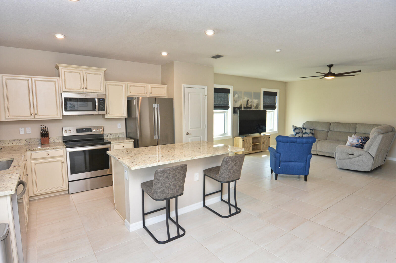 3524 Carriage Pointe Circle Fort Pierce, FL 34981 - Photo 7 of 55 a kitchen with a refrigerator and a stove top oven