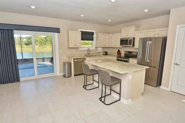 a kitchen with refrigerator a stove a microwave and cabinets