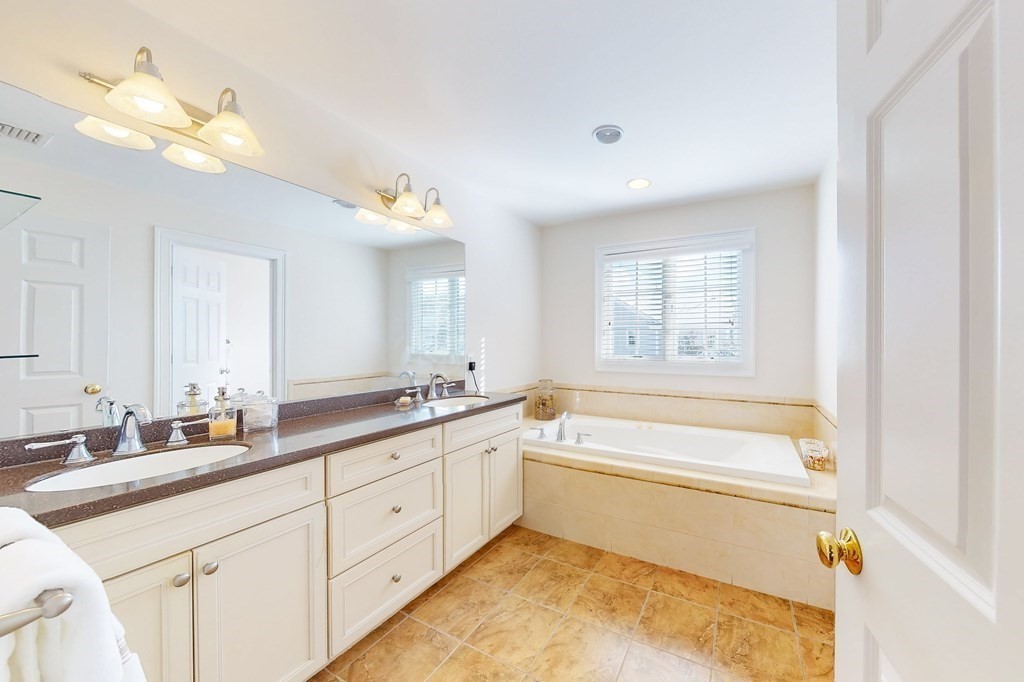 94 Arch Street Needham, MA 02492 - Photo 11 of 23 a spacious bathroom with a tub double sink mirror and