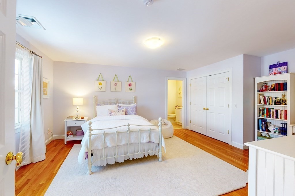 94 Arch Street Needham, MA 02492 - Photo 12 of 23 a bedroom with a bed and a book shelf