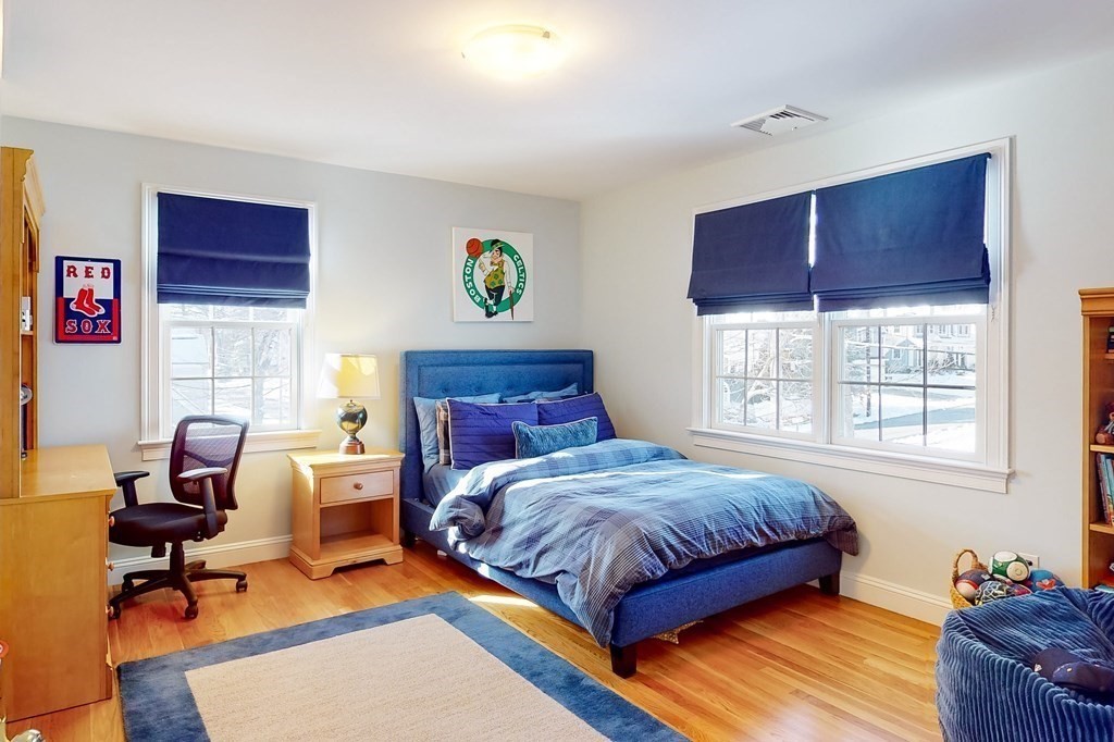 94 Arch Street Needham, MA 02492 - Photo 13 of 23 a bedroom with a bed and wooden floor