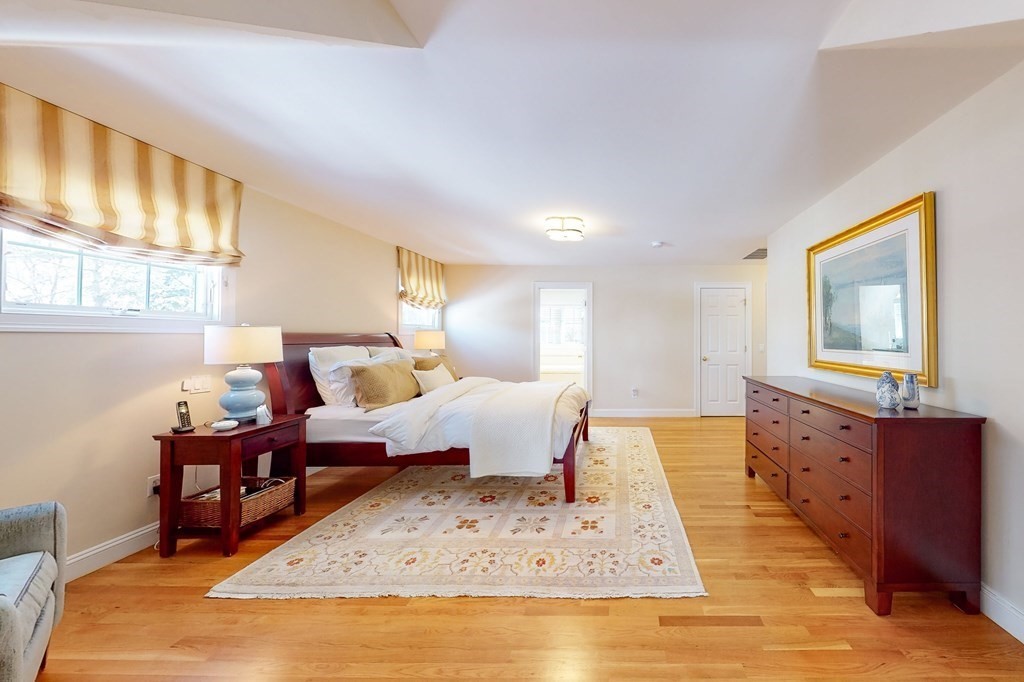 94 Arch Street Needham, MA 02492 - Photo 9 of 23 a bedroom with furniture window and wooden floor