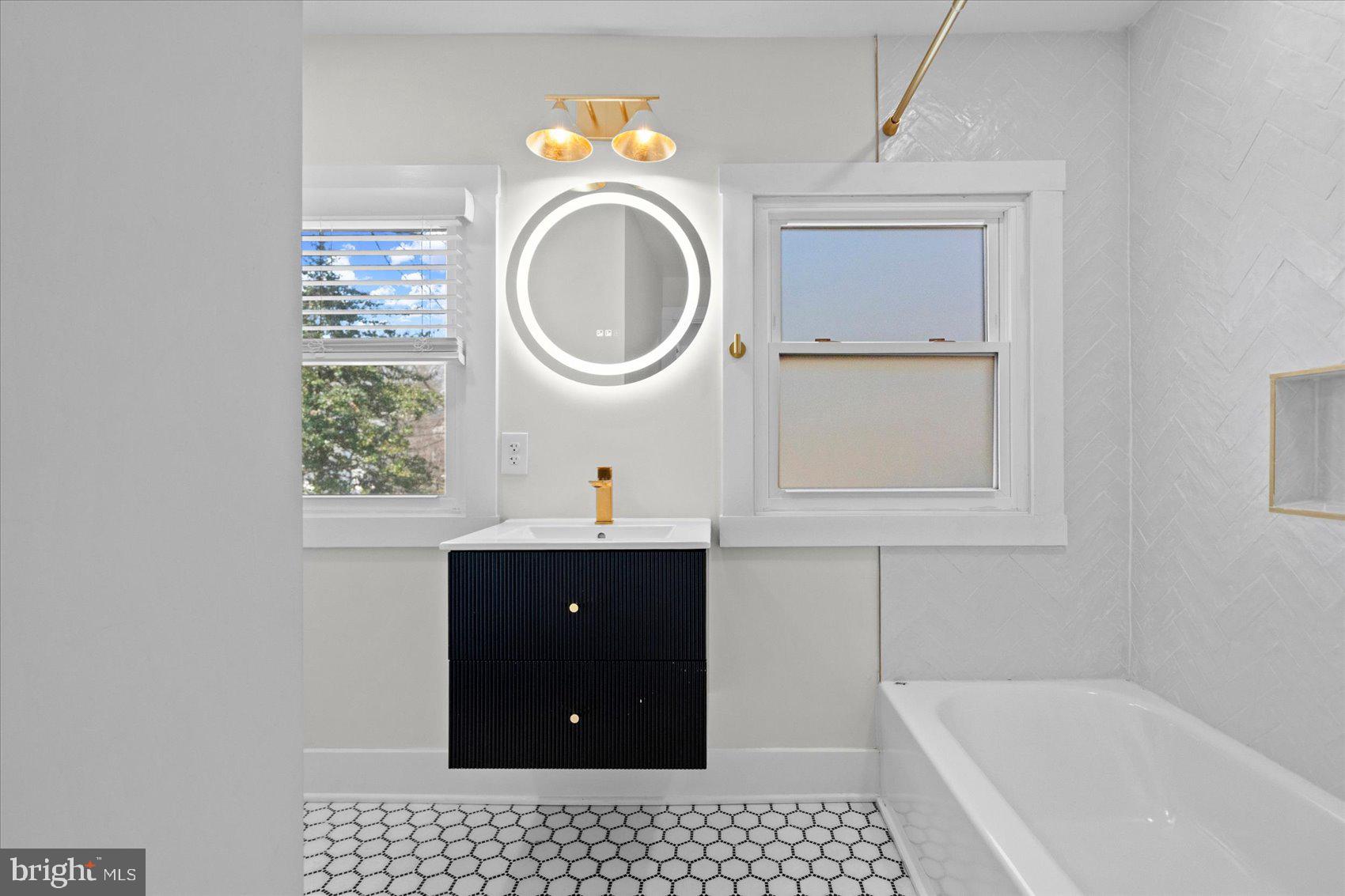 510 Overcrest Road Towson, MD 21286 - Photo 31 of 47 a bathroom with a sink a bathtub and a window