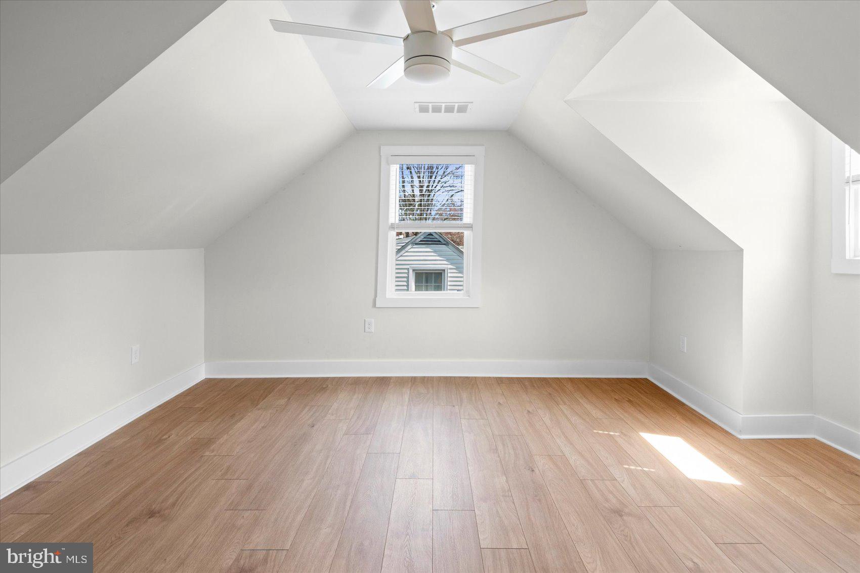510 Overcrest Road Towson, MD 21286 - Photo 33 of 47 an empty room with wooden floor chandelier and windows