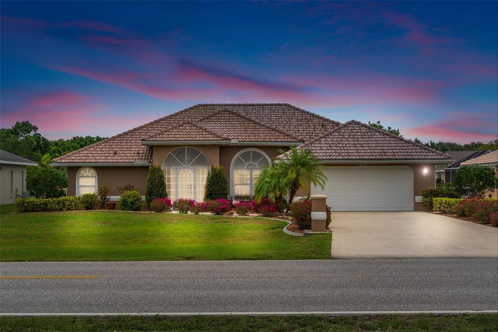 26082 Rampart Boulevard Punta Gorda, FL 33983 - Photo 1 of 1 a front view of a house with a yard and garage