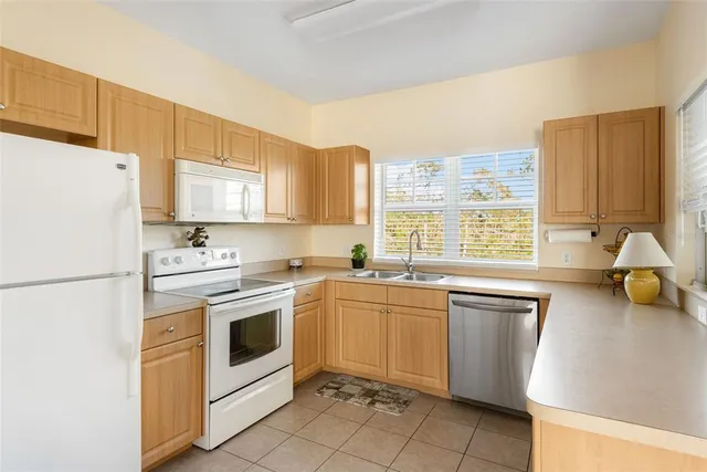a bathroom with a granite countertop toilet a sink and a mirror