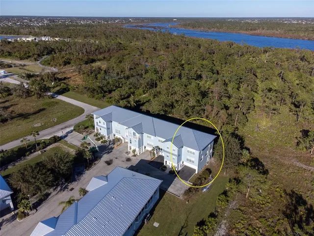 an aerial view of a house with a ocean view