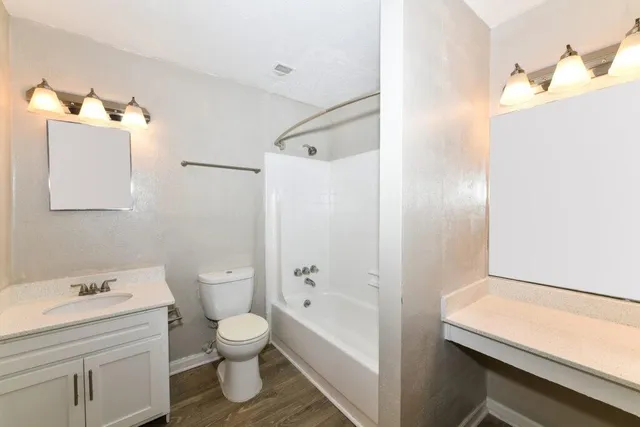 a bathroom with a toilet a sink and bathtub