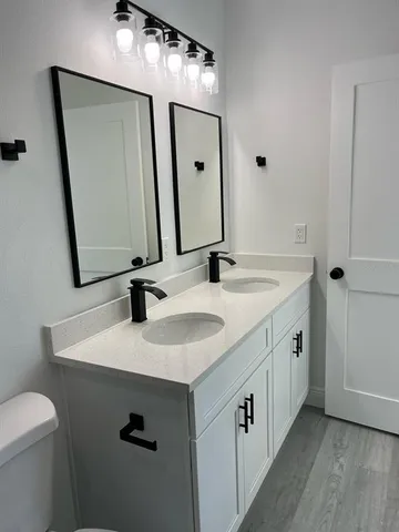 a bathroom with a double vanity sink and a mirror