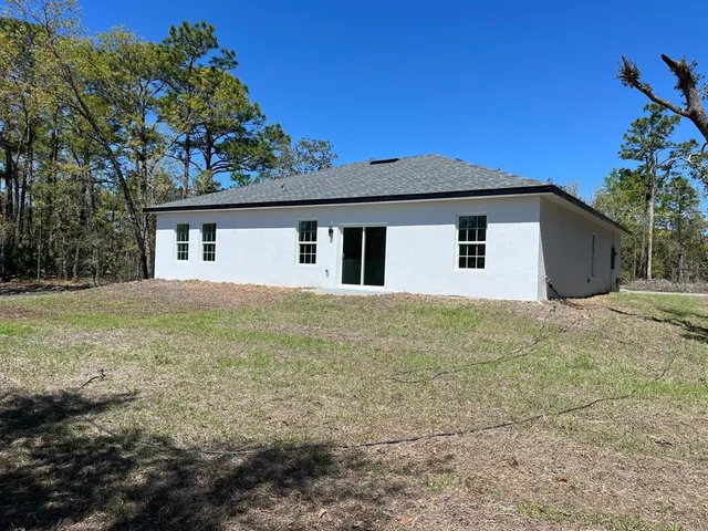 a house with trees in the background