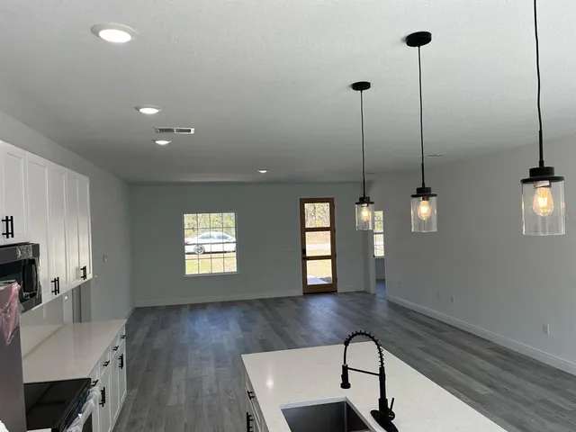 a view of a room with window and wooden floor