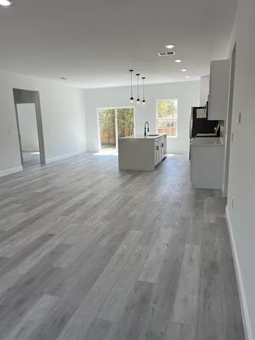 a view of kitchen with wooden floor and electronic appliances