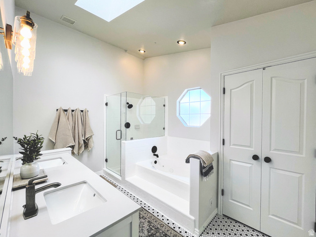 12169 Hidden Valley Road, Unit 44 Sandy, UT 84092 - Photo 22 of 49 White vanity with dual integrated sinks and bronze-finish fixtures