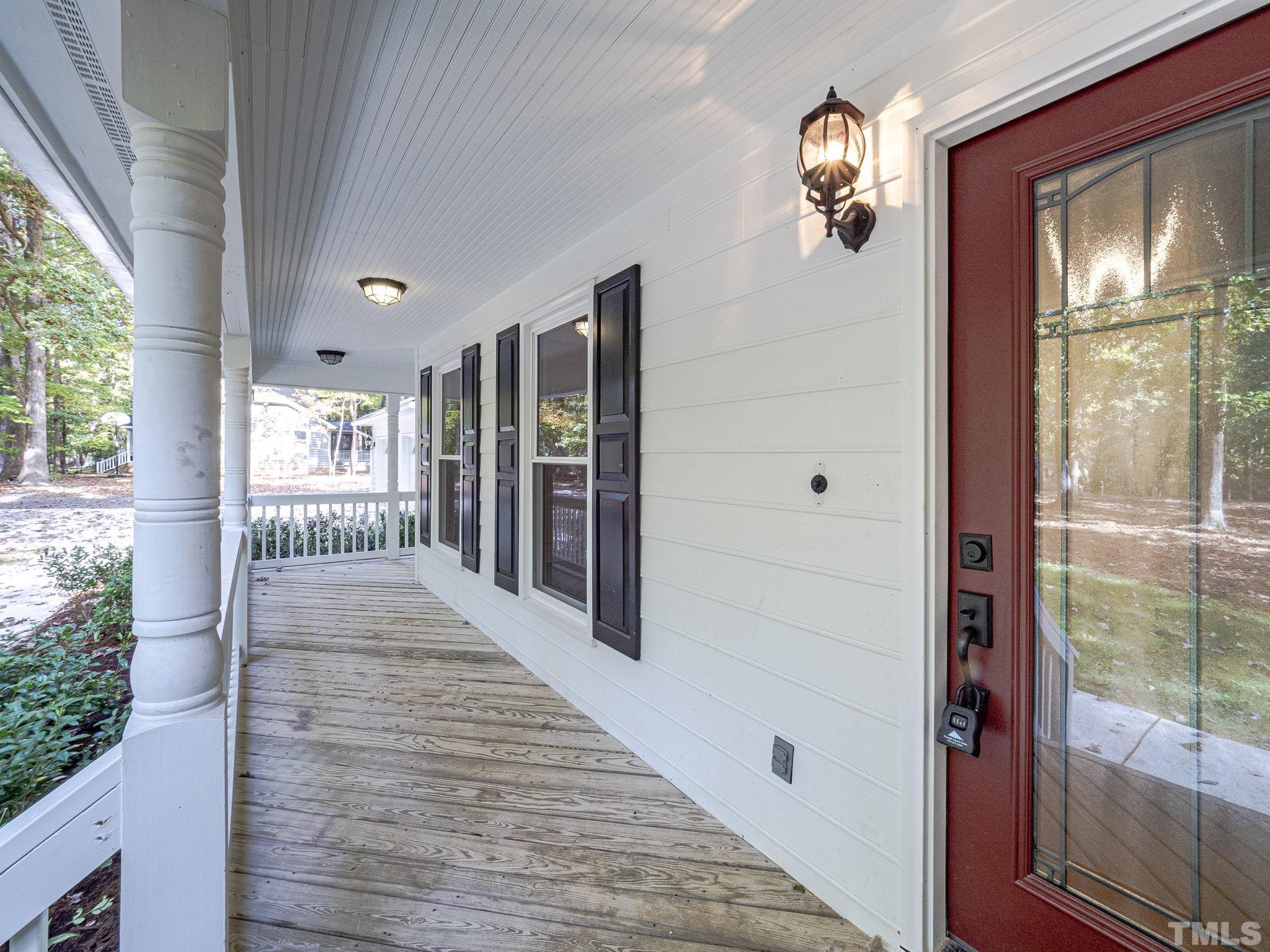 11936 Appaloosa Run East Raleigh, NC 27613 - Photo 2 of 30 a view of a hallway with wooden floor and windows