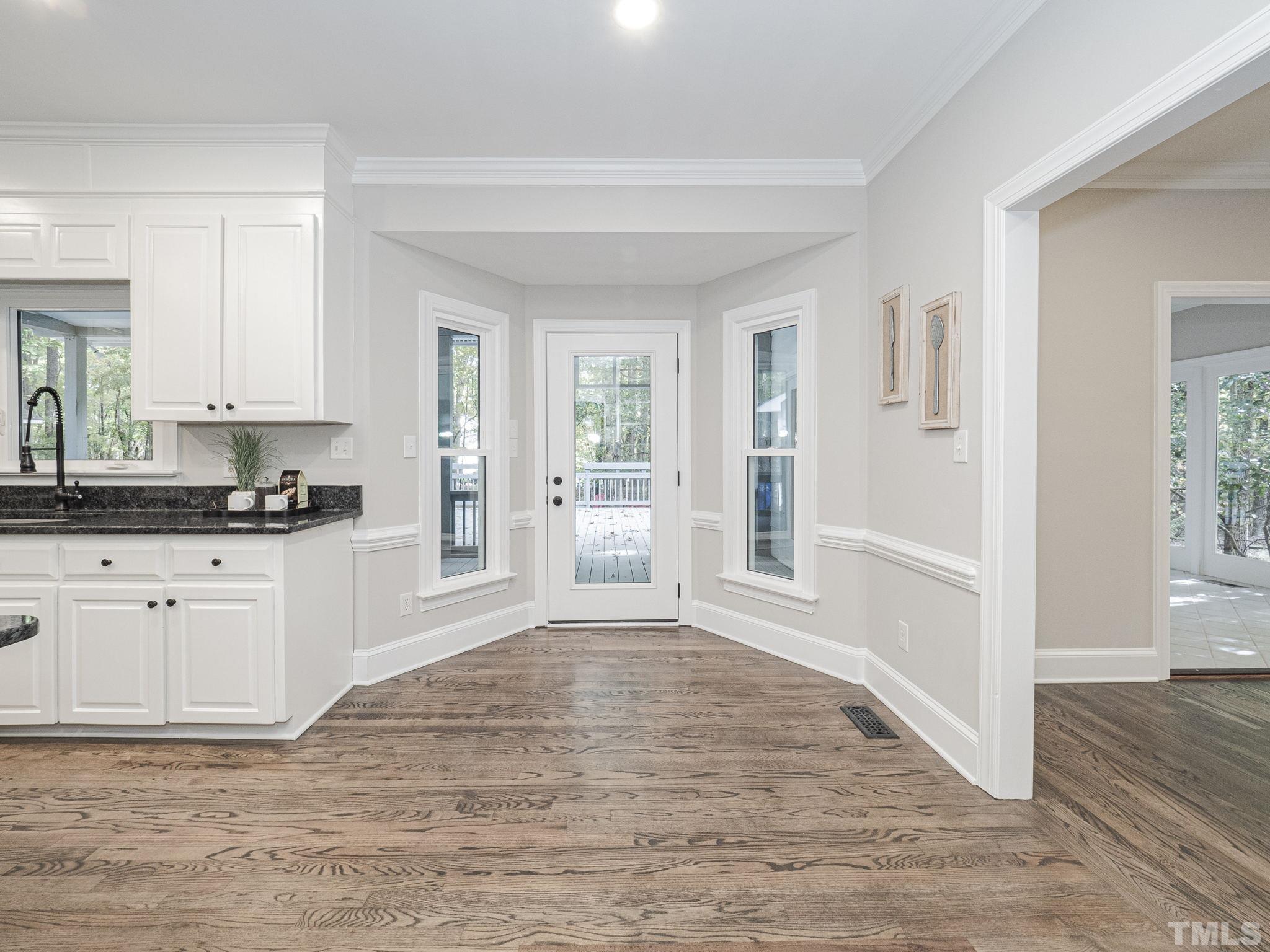 11936 Appaloosa Run East Raleigh, NC 27613 - Photo 14 of 30 a view of a kitchen with wooden floor and electronic appliances