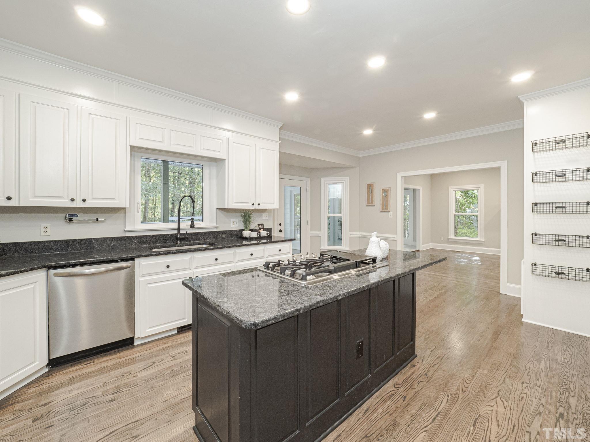11936 Appaloosa Run East Raleigh, NC 27613 - Photo 16 of 30 a kitchen with a sink stove and cabinets