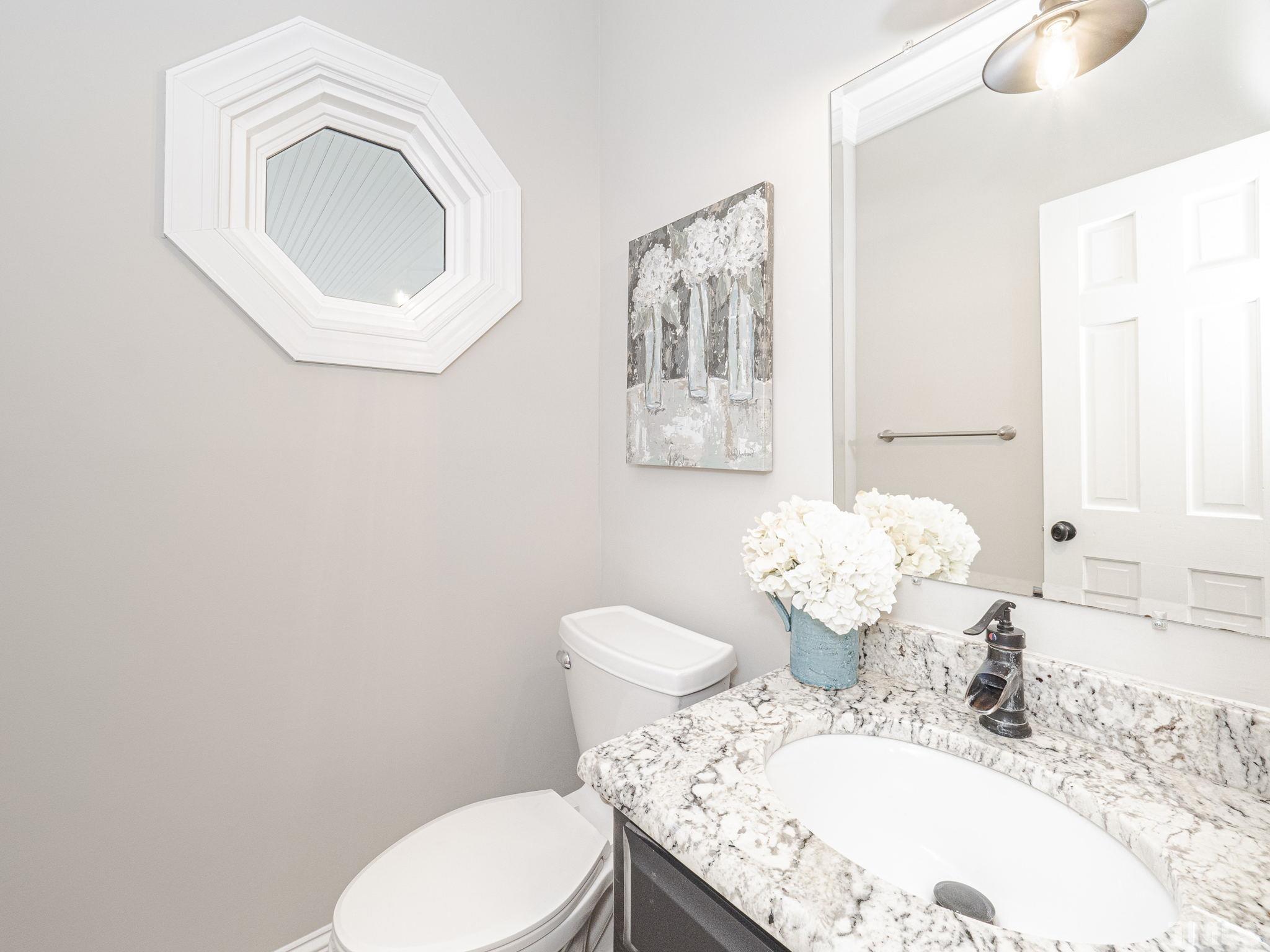 11936 Appaloosa Run East Raleigh, NC 27613 - Photo 18 of 30 a bathroom with a granite countertop toilet sink and mirror
