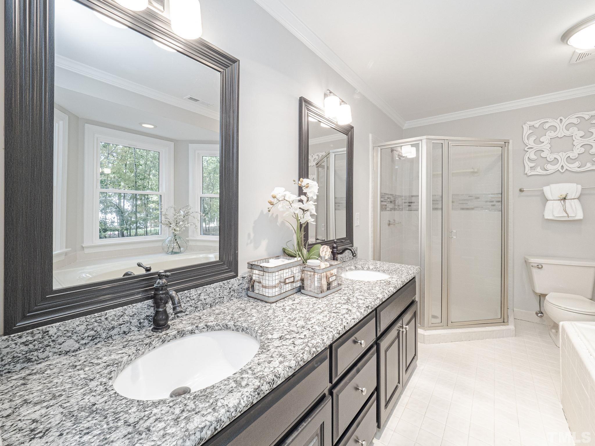 11936 Appaloosa Run East Raleigh, NC 27613 - Photo 22 of 30 a bathroom with a granite countertop sink and a mirror