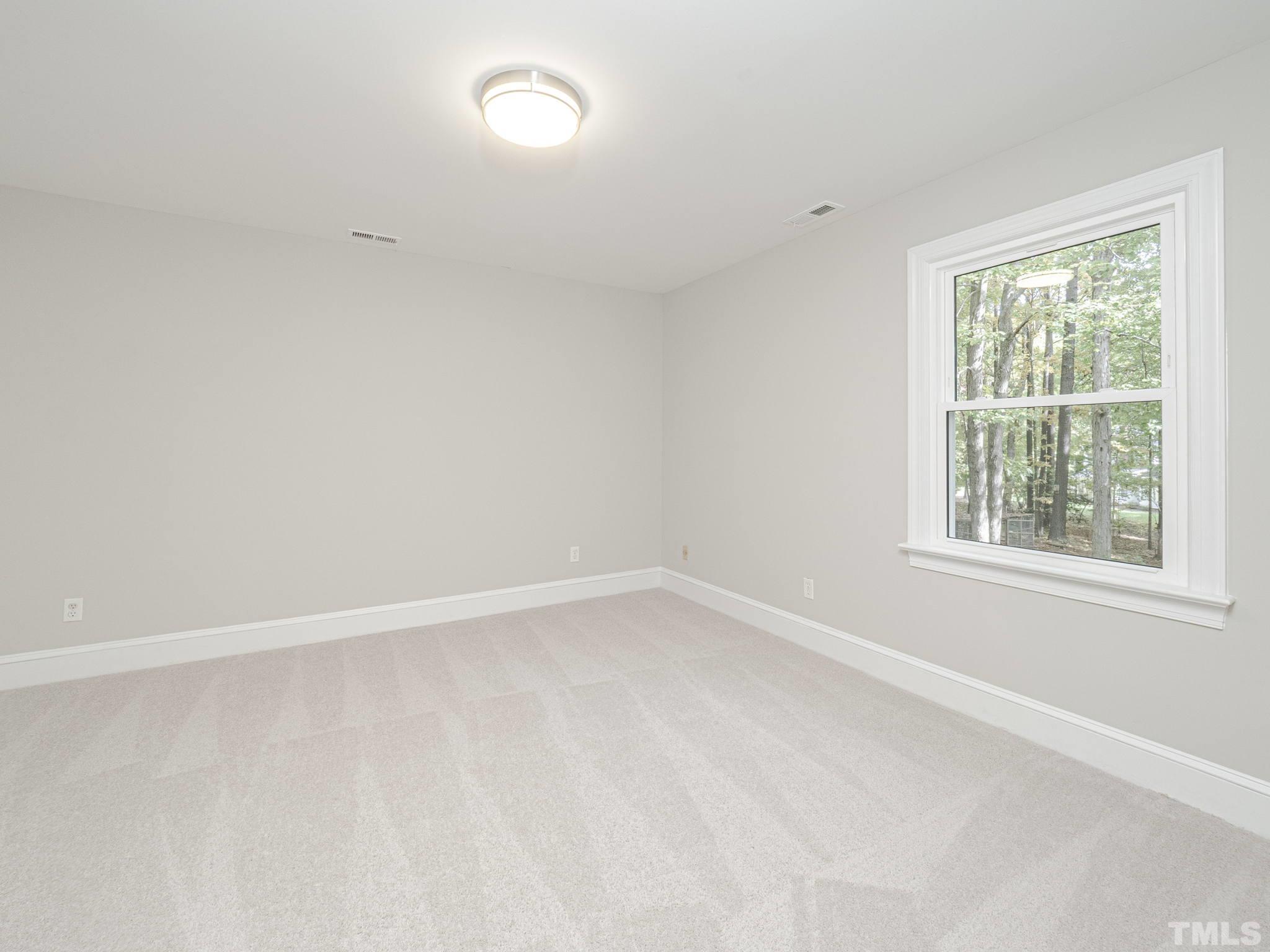 11936 Appaloosa Run East Raleigh, NC 27613 - Photo 23 of 30 an empty room with a window