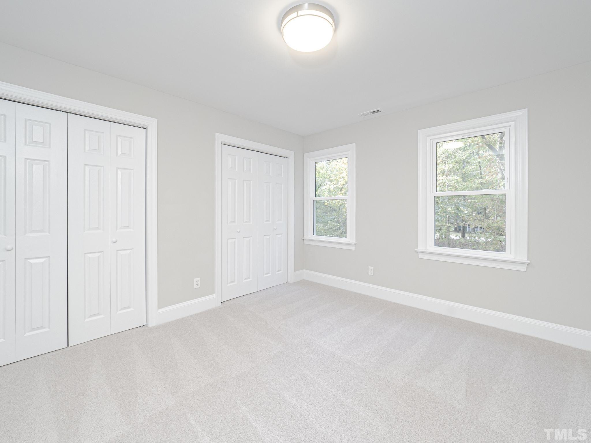 11936 Appaloosa Run East Raleigh, NC 27613 - Photo 26 of 30 an empty room with windows and closet