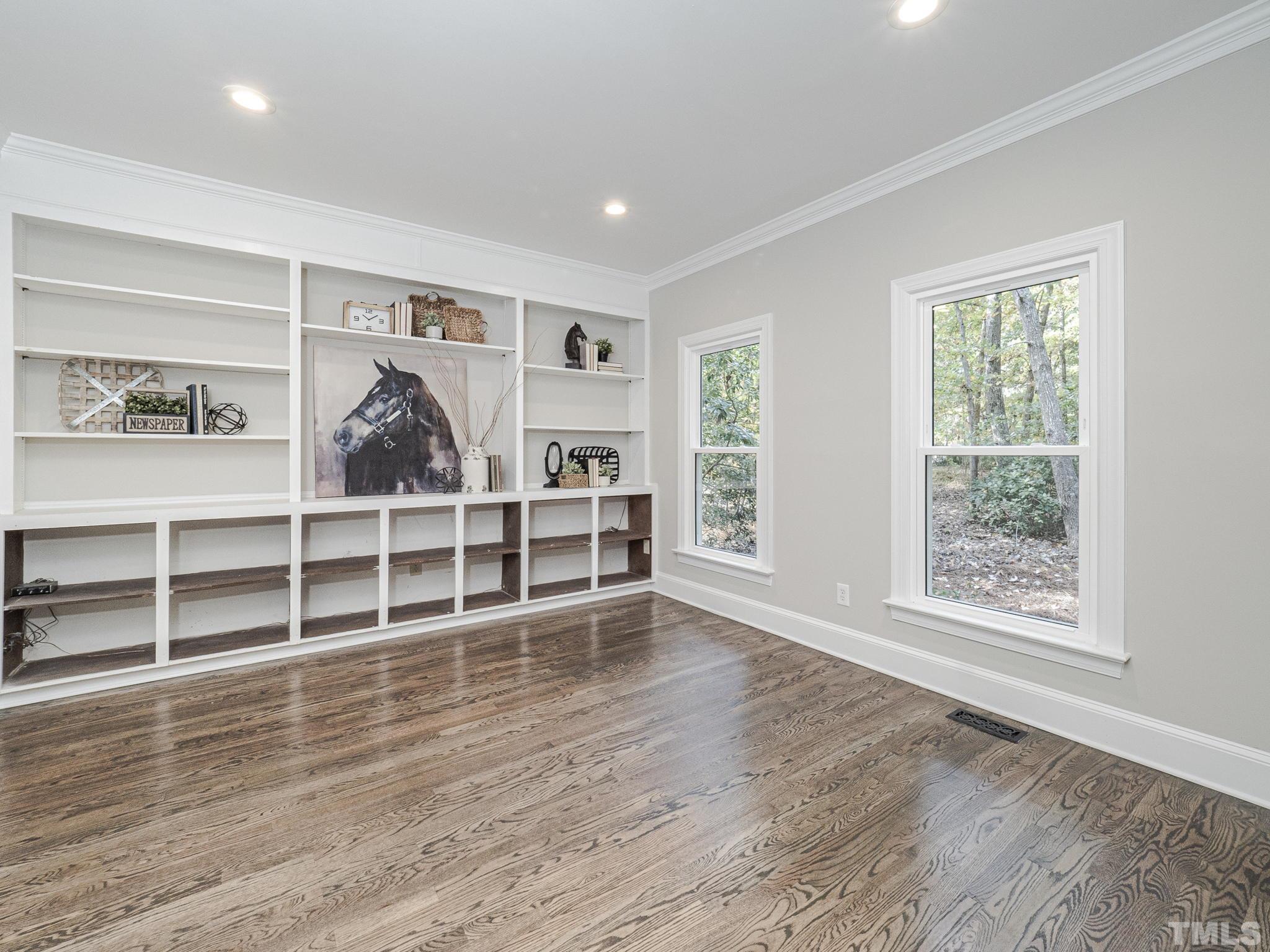 11936 Appaloosa Run East Raleigh, NC 27613 - Photo 4 of 30 a view of a livingroom with wooden floor and windows