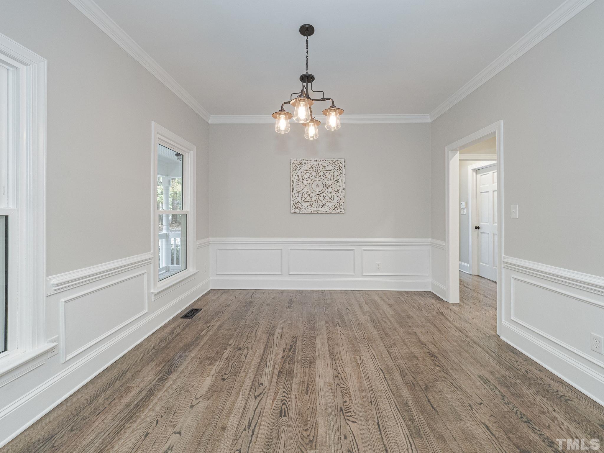 11936 Appaloosa Run East Raleigh, NC 27613 - Photo 5 of 30 a view of wooden floor chandelier and window in a room
