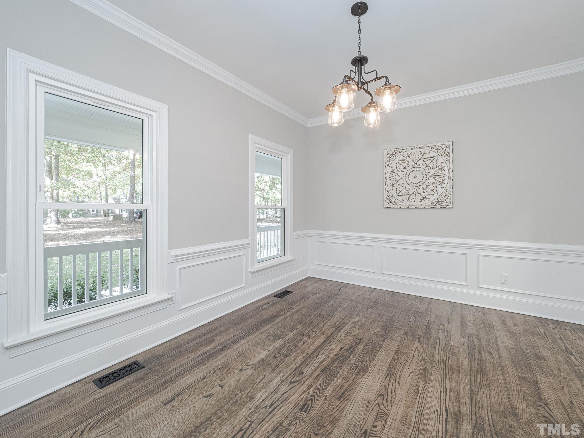 11936 Appaloosa Run East Raleigh, NC 27613 - Photo 6 of 30 a view of empty room with wooden floor and fan