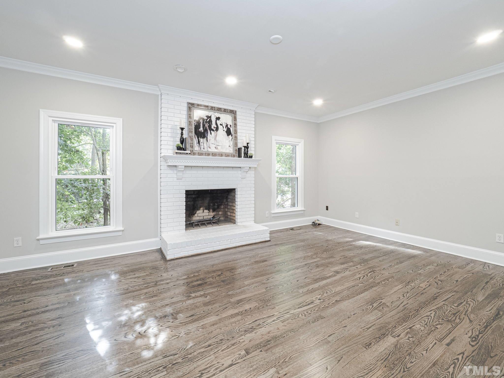 11936 Appaloosa Run East Raleigh, NC 27613 - Photo 7 of 30 a view of an empty room with a window and fireplace
