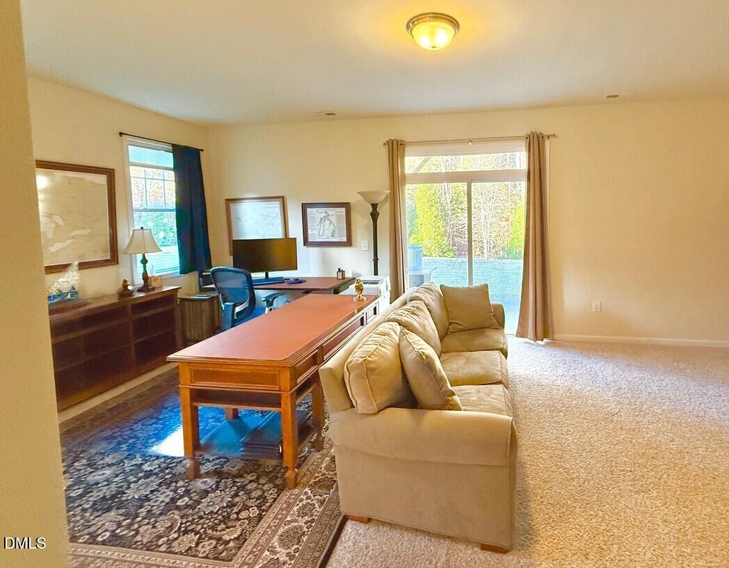 634 Edgewater Ridge Court Apex, NC 27523 - Photo 19 of 23 a living room with furniture and a rug