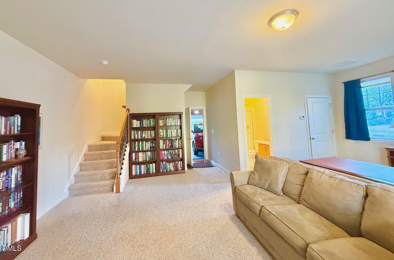634 Edgewater Ridge Court Apex, NC 27523 - Photo 20 of 23 a living room with furniture and a large window
