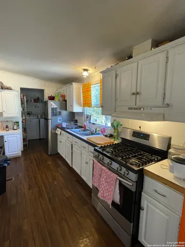 a kitchen with stainless steel appliances granite countertop a stove and cabinets