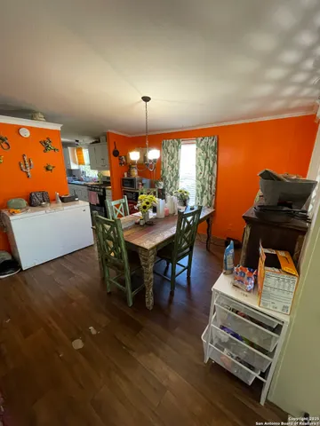 a view of a dining room with furniture and chandelier