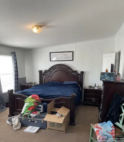 a living room with furniture and a baby crib