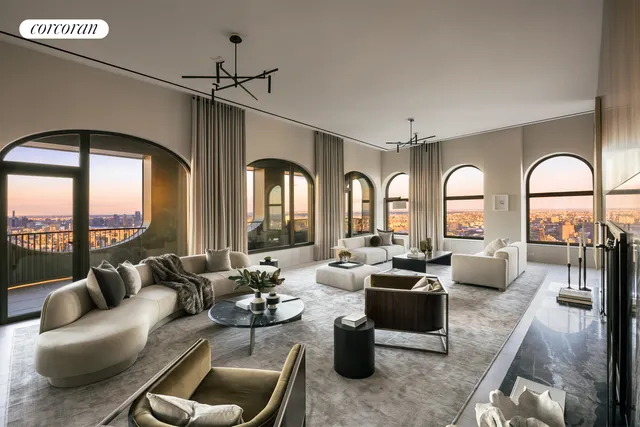 a living room with furniture fireplace and floor to ceiling windows