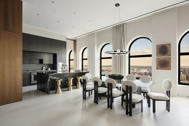 a living room with furniture fireplace and floor to ceiling windows