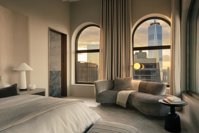 a front view of a house with large windows and couches