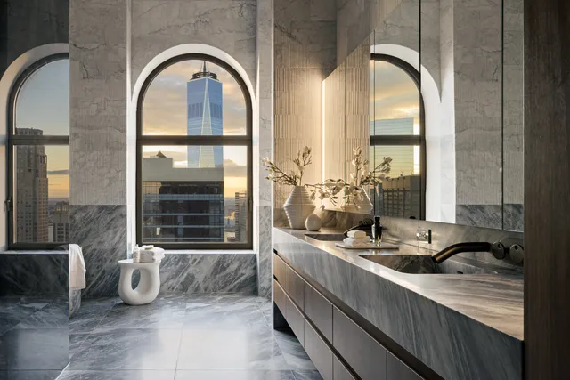 a living room with bed furniture and a floor to ceiling window