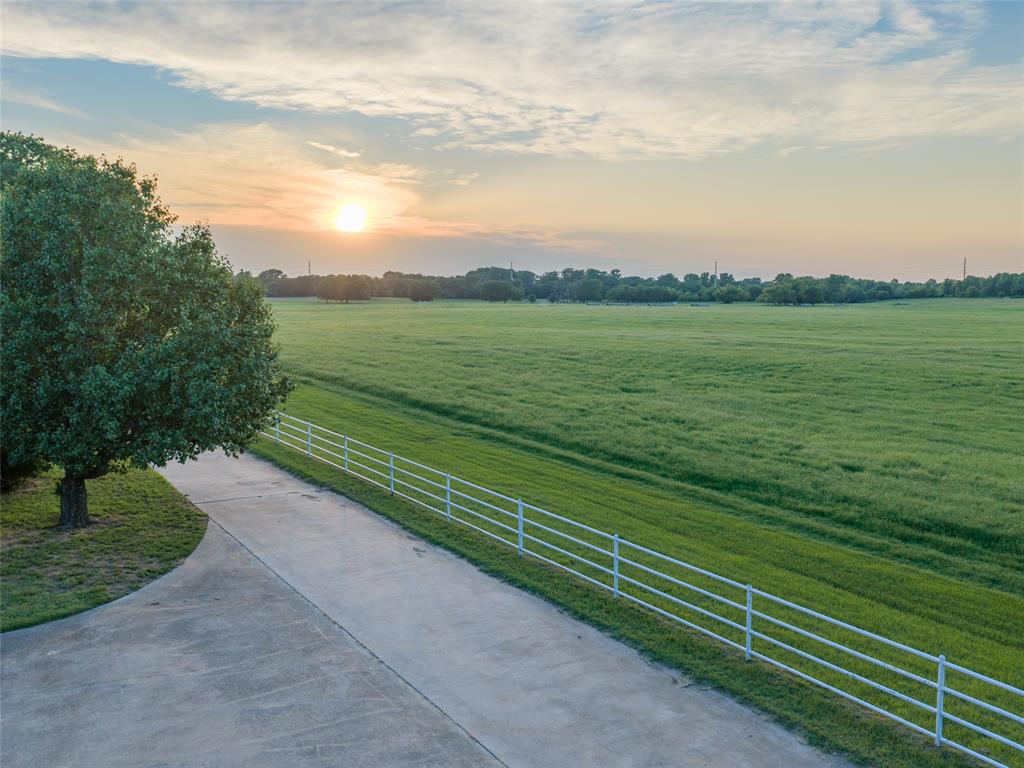449 Private Road 4670 Rhome, TX 76078 - Photo 1 of 39 a view of a green field with wooden fence