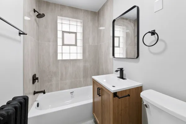 a bathroom with a sink toilet and tub