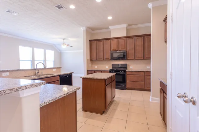 a kitchen with a stove a sink and a refrigerator