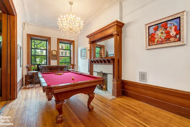 a room with pool table and windows