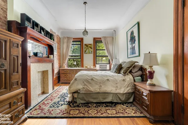 a bedroom with bed and large windows