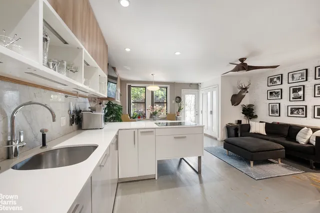 a kitchen with white cabinets a sink and appliances