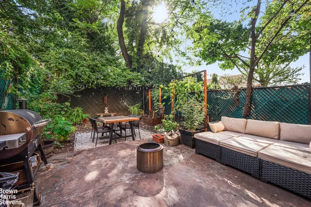 a balcony with wooden floor table and chairs