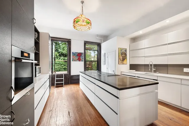 a view of a living room and kitchen with a large window
