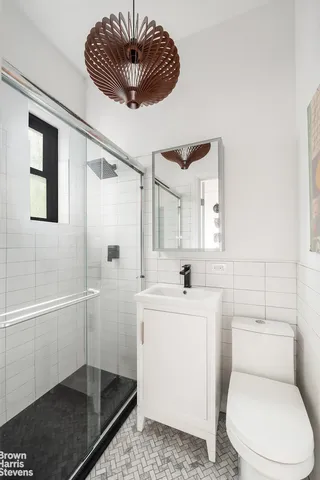 a kitchen with kitchen island granite countertop a stove and a wooden floors